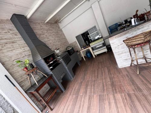 a living room with a fireplace and a table and chairs at Casa do Marcus in Barra do Garças