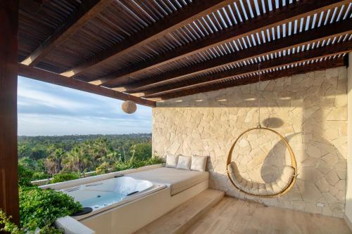 a bath tub sitting on top of a patio at Hacienda Todos Los Santos in Todos Santos