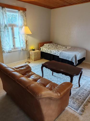 a living room with a couch and a bed at Majatalo Eura in Eura