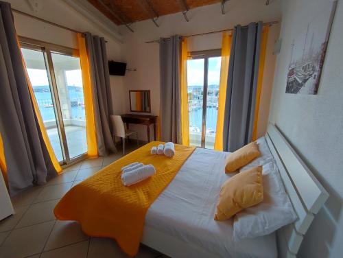 a bedroom with a bed with two towels on it at Chèz Cocò in La Maddalena