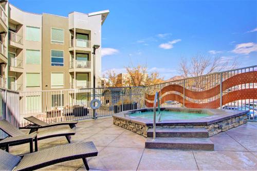 a patio with a hot tub and benches and a building at Ultra-Luxury 2BR Downtown Condo in Salt Lake City
