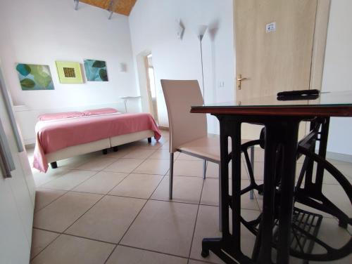 a bedroom with a bed and a table and chairs at Chèz Cocò in La Maddalena