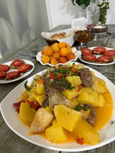 a table with plates of food on a table at Ak-keme in Tossor