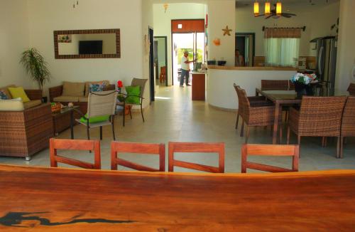 a living room with a bunch of chairs and a table at Hidra luxurious accommodation in San Benito