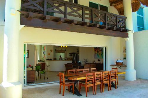 a dining room with a wooden table and chairs at Hidra luxurious accommodation in San Benito