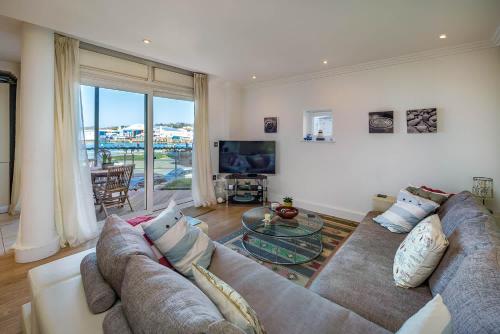 a living room with a couch and a glass table at Marina View in Cowes