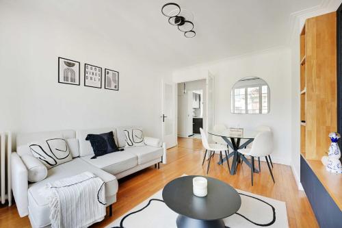 un salon blanc avec un canapé blanc et une table dans l'établissement Modern apartment - Saint-Mandé - 1BR 4P, à Saint-Mandé