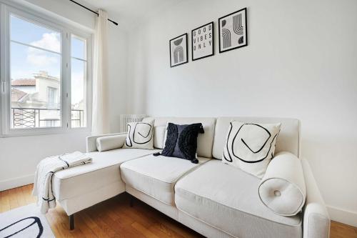 a white couch in a living room with a window at Modern apartment - Saint-Mandé - 1BR 4P in Saint-Mandé