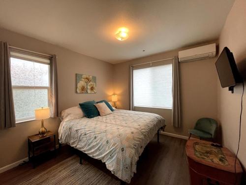 une chambre avec un lit et deux fenêtres dans l'établissement Tangerine Cottage, à Middletown