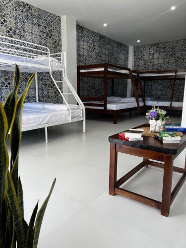 a room with two bunk beds and a coffee table at Villa Talisay - Beach house in Samal