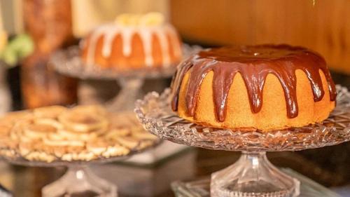 a cake on a glass plate on a table at HY Apartaments & Hotels-Boa Viagem in Recife