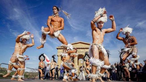 a group of men performing in a parade at Sikelia Suite Rooftop in Porto Empedocle