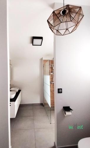 a bathroom with a sink and a pendant light at "Villa Maria" - Sublime vue Océan Classée 4 étoiles in Petite Île