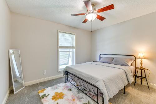 a bedroom with a bed and a ceiling fan at Boat Dock and Lift Waterfront Getaway in Slidell! in Slidell