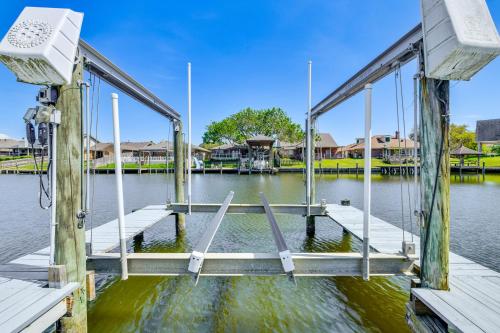 a dock on a body of water with houses at Boat Dock and Lift Waterfront Getaway in Slidell! in Slidell