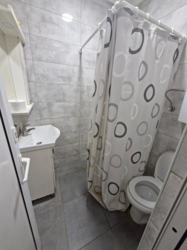 a bathroom with a toilet and a shower curtain at Konak Kod Gorana 1 in Subotica