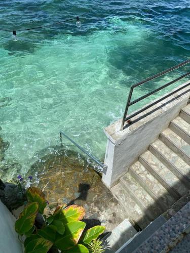 a group of people swimming in the water at Villa Talisay Ocean View in Samal