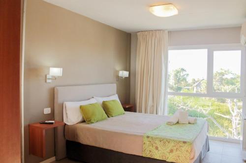 a bedroom with a bed and a large window at IQU Apart in Las Gaviotas