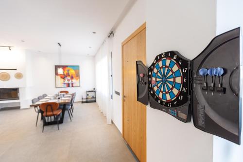 a room with a dart board on a wall at Beach Vibe Villa - Sunny Stay in O Ben Slimane