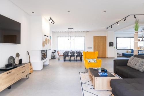 a living room with a couch and a table at Beach Vibe Villa - Sunny Stay in O Ben Slimane
