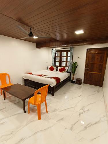 a bedroom with a bed and a wooden ceiling at The Mango Valley Nature's Stay in Alibag