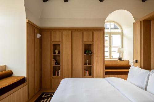 a bedroom with a white bed and a window at Stockholm Stadshotell in Stockholm
