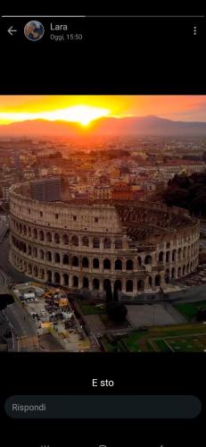 a view of a large building with a sunset in the background at Incantevole con Jacuzzi in Rome