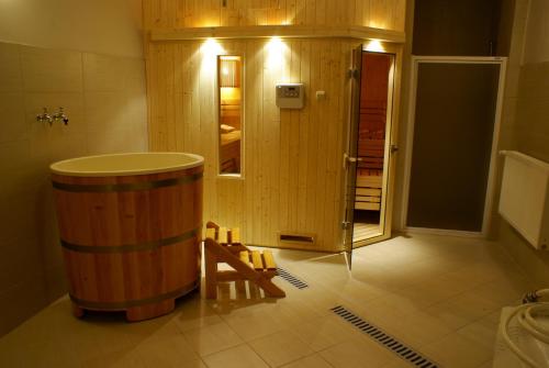 a large wooden barrel in a room with a door at Hotel Huszcza in Mrągowo