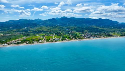 an aerial view of a beach with mountains in the background at Villa Pami in Almiros Beach