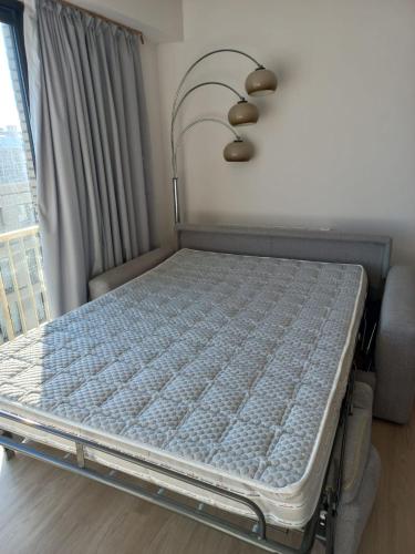 a bed in a room next to a window at Appartement vue mer in Koksijde