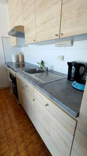 a kitchen with a sink and a counter top at Appartement vue mer in Koksijde