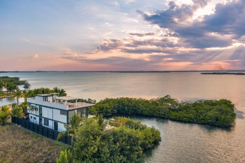 an aerial view of a house on a island in the water at Casa Balam in Placencia Village