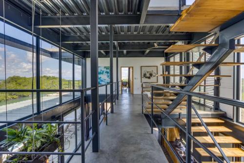 a staircase in a house with glass windows at Casa Balam in Placencia Village