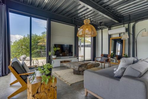 a living room with a couch and a tv at Casa Balam in Placencia Village