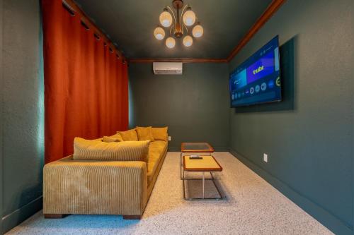 a living room with a couch and a tv at Monaco Vacation Rentals in Clearwater Beach