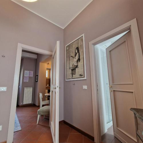 a hallway with two doors and a picture on the wall at Il Cortile di San Rufino in Assisi