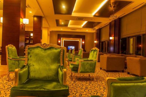 a waiting room with green chairs in a hotel at Linda Sunny Beach Hotel & Spa-Ultra All Inclusive in Side
