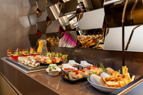 a buffet line with many different types of food at InterContinental São Paulo by IHG in Sao Paulo