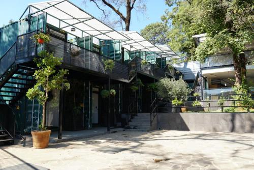 a house with a glass roof and stairs at Container Woods in Valle de Bravo