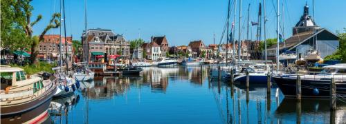 a group of boats are docked in a harbor at Chalet Schau aufs Meer - Traumlage erste Reihe in Dam
