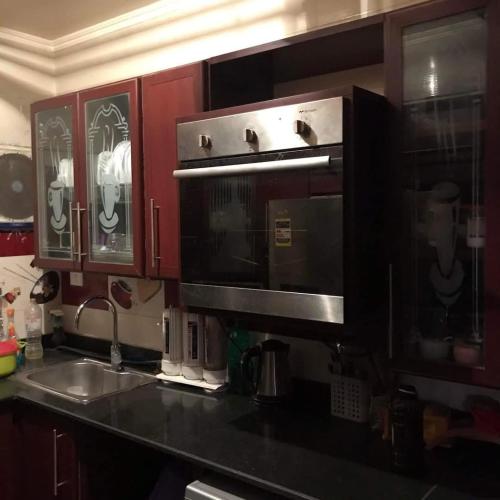 a kitchen with a sink and a microwave at birds House in Jerash
