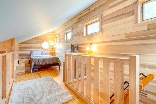 a wooden cabin with a staircase and a bed at Sawyers Cabin with Hot Tub in Blue Ridge Mtns! in Fletcher