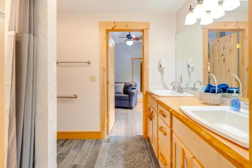 a bathroom with two sinks and a large mirror at Sawyers Cabin with Hot Tub in Blue Ridge Mtns! in Fletcher