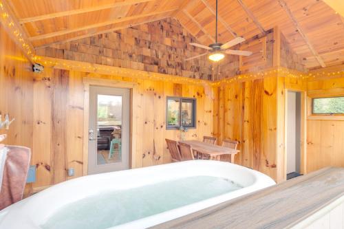 a bath tub in a room with a wooden ceiling at Sawyers Cabin with Hot Tub in Blue Ridge Mtns! in Fletcher