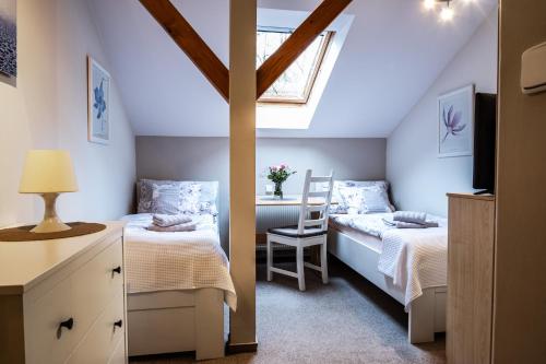 a bedroom with two beds and a window at Penzion Pohoda Sokolov in Sokolov