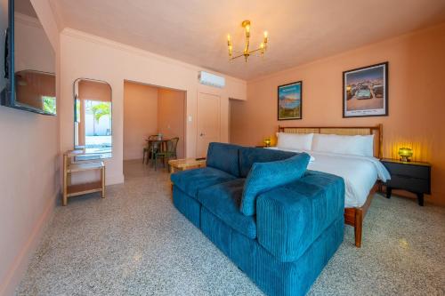 a hotel room with a bed and a blue couch at Monaco Vacation Rentals in Clearwater Beach