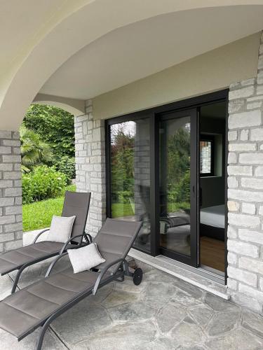 a patio with two chairs and a sliding glass door at Residence Le Primule in Stresa