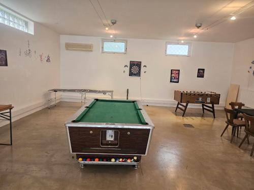 a room with a pool table in the middle of it at Ferienwohnung Katharina in Steinbach am Attersee
