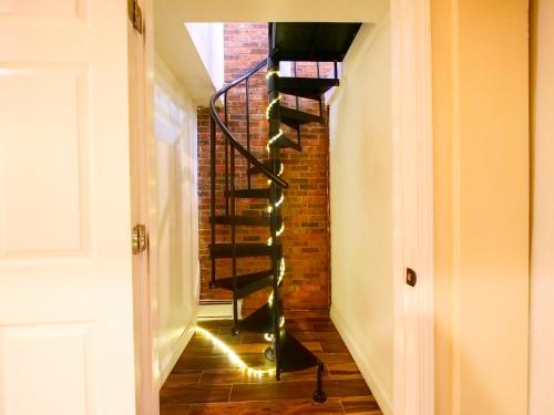 a spiral staircase with lights in a hallway at Stylish 3 bed, minutes to NYC! in Jersey City