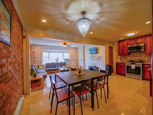 a kitchen and dining room with a table and chairs at Stylish 3 bed, minutes to NYC! in Jersey City